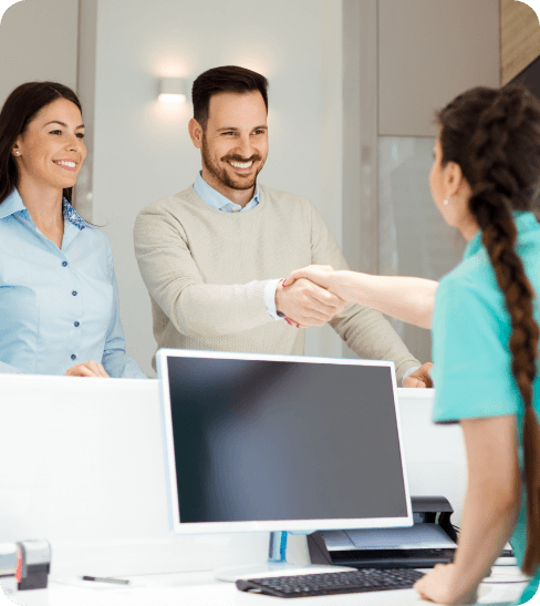 photo of smiling couple talking to team member